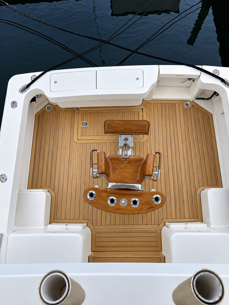 The cockpit from above: teak deck and a varnished fighting chair