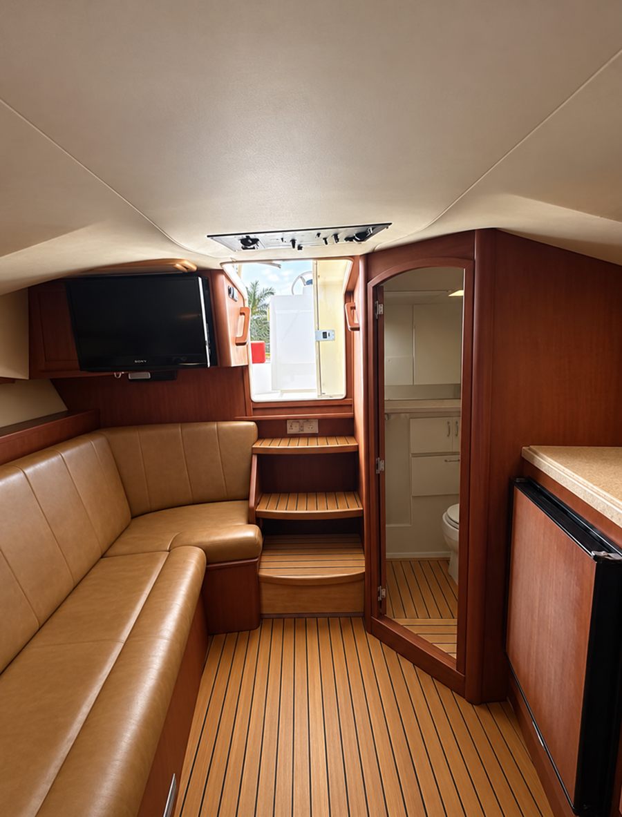 The cabin below: a tan leather settee and teak sole